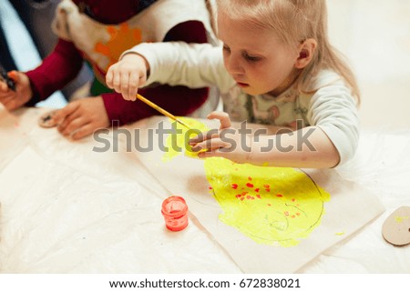 A cute child draws the picture. Kids creativity.