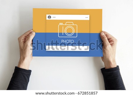 Hands holding placard with social media camera icon