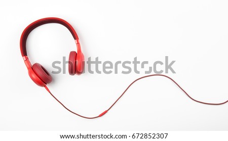 Red headphone and cable isolate on white background. Royalty-Free Stock Photo #672852307