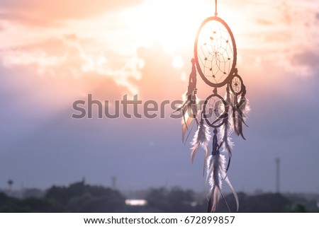 Dreamcatcher sunset ,boho chic, ethnic amulet,symbol Royalty-Free Stock Photo #672899857