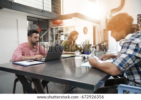 Trendy young people working in co-working office  Royalty-Free Stock Photo #672926356