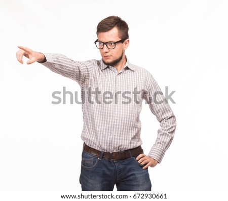 Young confident man showing by hands on a gray background. Ideal for banners, registration forms, presentation, landings, presenting concept.