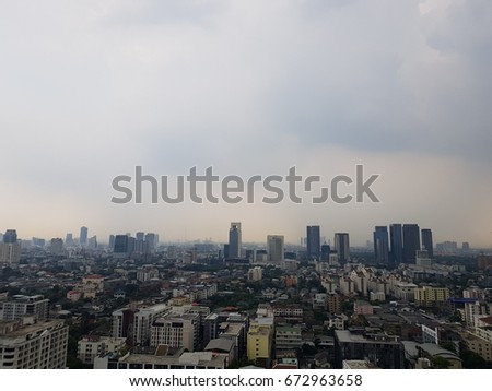 Cityscape under clouds and blue sky