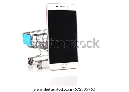 Smartphone and shopping cart on white background. Online shopping concept. Online shopping is an electronic commerce which allows consumers to directly buy goods from a seller over the Internet. 
