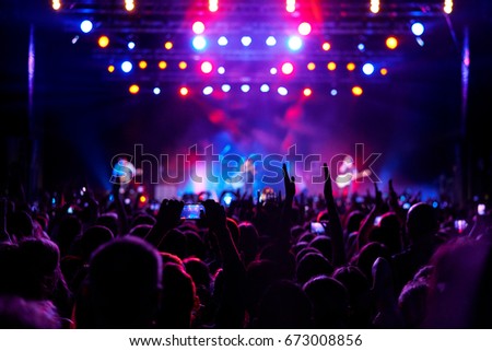 Stage, concert light. People are watching a rock concert. Royalty-Free Stock Photo #673008856