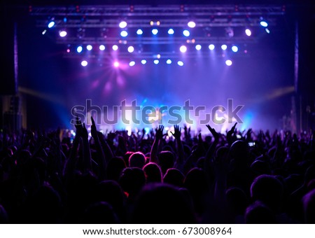 Stage, concert light. People are watching a rock concert. Royalty-Free Stock Photo #673008964