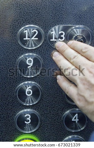 a person touching the braille inscription in a lift numbers