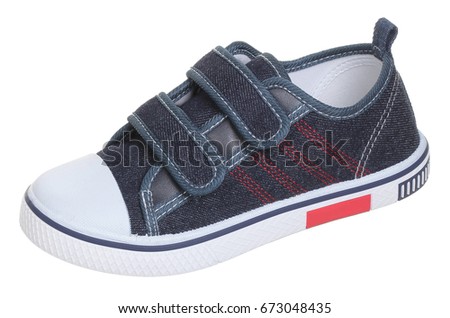 Side upper view of male dark blue, red and white textile gumshoe (sneaker) with velcro clasp and rubber sole, isolated on white