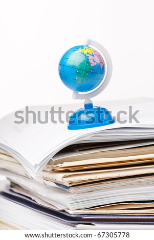 globe on the stack of paper