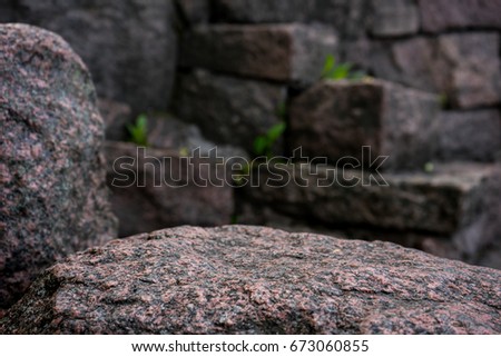Natural stone board empty  in front of blurred stones background. Can be used for display or montage mock up your products.