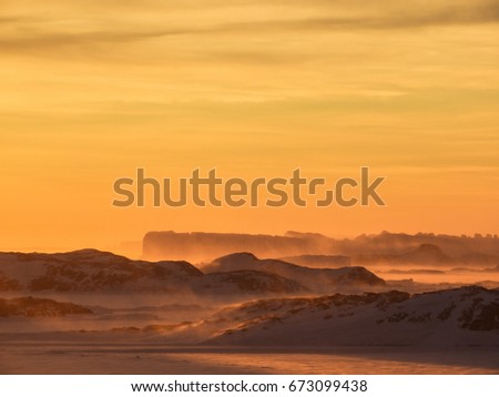 The beauty of windy Antarctica during sunset. These pictures were taken near Larsemann hills, Antarctica on 05-16-2017. The beauty of sky filled with the reflection from sun is truly amazing.