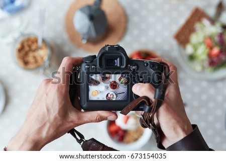 Professional food-photographer making shot of food for advert Royalty-Free Stock Photo #673154035