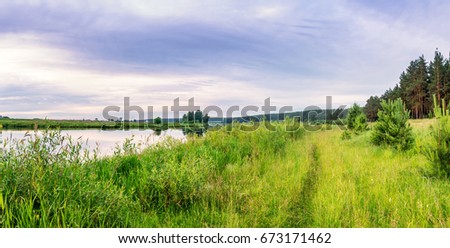evening summer landscape on the banks of the Ural river with grass, Russia, July