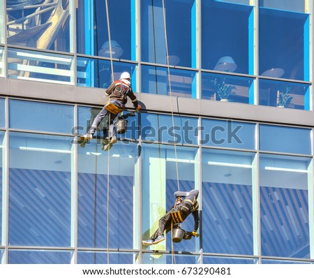 Spiderman washing Windows in high-rise building