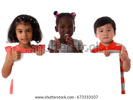 Portrait three of multiracial kids in studio with white board on white background