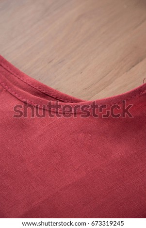 Stacked of red fabric on wooden background vintage style. 