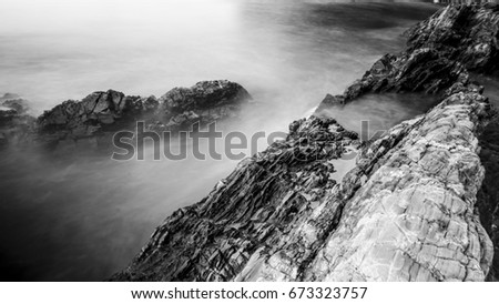 Seascape with rocks using long exposure - black and white