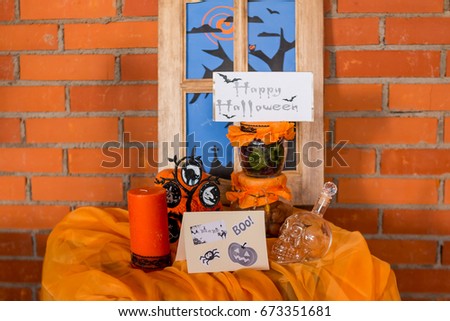 Halloween home decorations with spiders and pumpkin bucket for trick or treat. Greeting Card. Halloween pumpkin brick background. Happy Halloween picture. Ideas for Halloween. Indoor decoration.