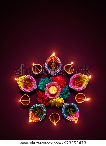 Colorful diya lamps lit during diwali celebration Royalty-Free Stock Photo #673355473
