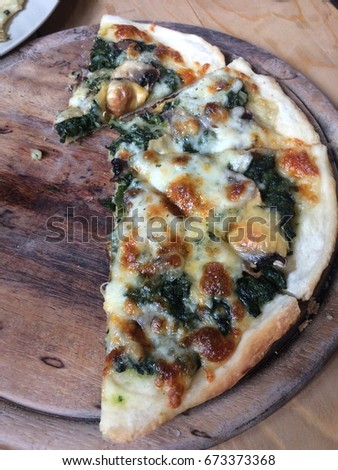Spinach pizza with mushrooms
