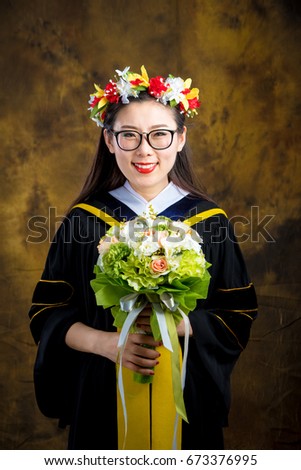 chinese girl in graduation dress on brown background