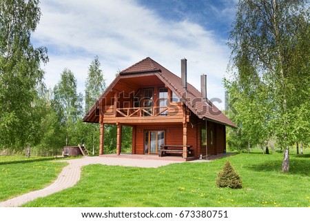 Wooden cottage. Royalty-Free Stock Photo #673380751