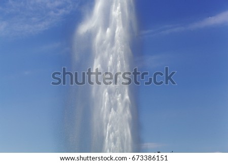 A water fountain with a blue sky.