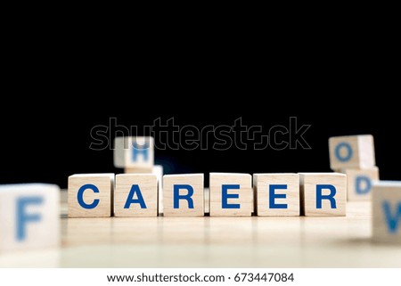 Wood cube and word career on wooden table with black background