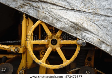 Yellow hand wheel are covered with raincoats