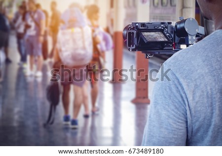 man videographer takes video with camera on the stabilizer Royalty-Free Stock Photo #673489180