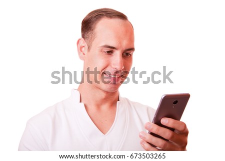 portrait of young man texting on a mobile phone on a white background