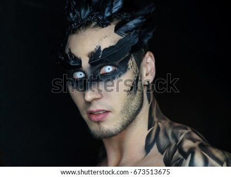 Make-up of a raven or another bird on a man