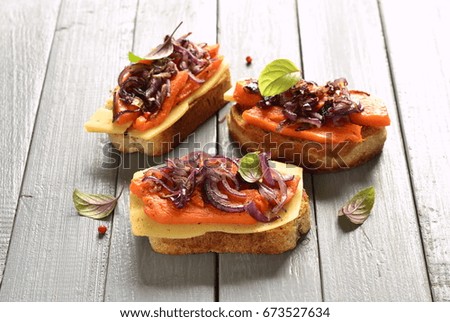 Bruschetta with roasted pumpkin, cheese and fried onions