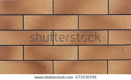 Texture of a yellow brown glossy mosaic tile