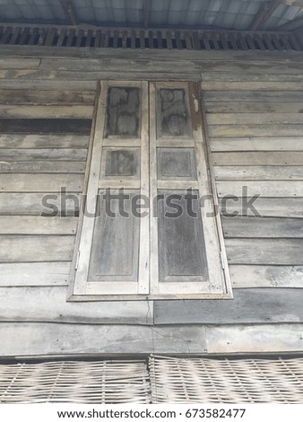 Old weathered wooden window with hinges