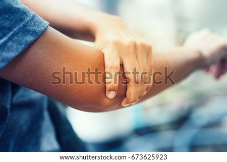 young women having pain in injured arm , office syndrome , health care concept Royalty-Free Stock Photo #673625923