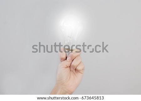 Woman's hand holds an incandescent electric bulb that shines. Creating an Idea. Technologies.