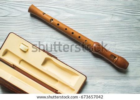Wood block flute on white wood background