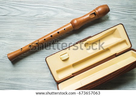 Wood block flute on white wood background Royalty-Free Stock Photo #673657063