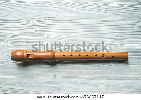 Wood block flute on white wood background Royalty-Free Stock Photo #673657117