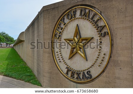 The seal of the City of Dallas dates back to 1871 and is located on a street wall just outside the entrance to City Hall.