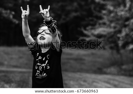 Heavy Metal Kid/Rock and Roll Child Royalty-Free Stock Photo #673660963