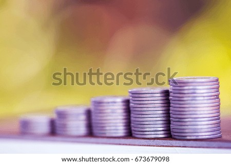 Row of coins on wood background for finance and Saving concept,Investment, Economy, Soft focus.