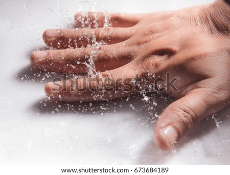 hand touch water on white background