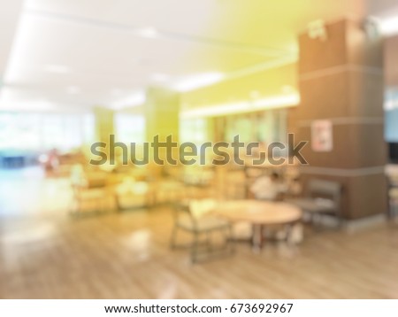 blurred image of public library or book store with woman reading. Concept for background, bookstore, examination, graduation, education, student, research in university
