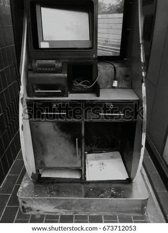 The old, worn-out Automatic Teller Machin(ATM) was left unused. Black and white picture.