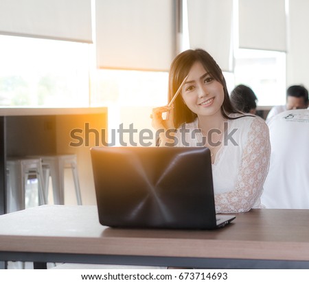 Proud freelance woman posing at office and looking at you / soft focus picture 