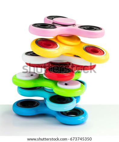Spinners are a variety of colors that overlap with balance on a white background.
