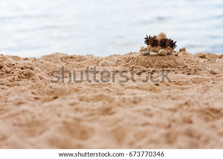 Beach buildings made of sand, sand castle, sand pyramid on the beach
