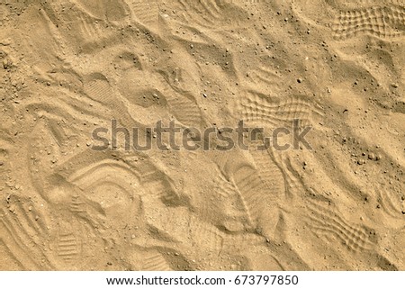 Footprints in sand on playpit. Top view. Sand in sand-pit, overhead shot. Sandbox background. Sandpit desktop background. Moulding sand quarry desktop picture. 